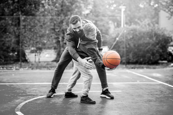 Man och pojke spelar basket lediga familjehem